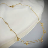 A classic must-have to complement any look, this rainfall 18k gold necklace features seven dangling set diamonds