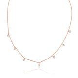 A classic must-have to complement any look, this rainfall 18k gold necklace features seven dangling set diamonds