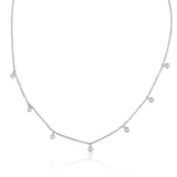 A classic must-have to complement any look, this rainfall 18k gold necklace features seven dangling set diamonds