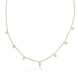 A classic must-have to complement any look, this rainfall 18k gold necklace features seven dangling set diamonds