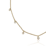 A classic must-have to complement any look, this rainfall 18k gold necklace features seven dangling set diamonds