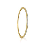 A classic thin Diamond bangle bracelet, elegant, effortless on its own and magnificent layered. The bangle has a safety clasp to keep it in place.  Available in 18K yellow, white and rose Gold.