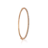 A classic thin Diamond bangle bracelet, elegant, effortless on its own and magnificent layered. The bangle has a safety clasp to keep it in place.  Available in 18K yellow, white and rose Gold.