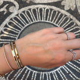 14K solid Gold (8.2g), 7 Diamonds (0.35 carats) A gorgeous classic bangle bracelet with 7 perfect diamonds that would go perfectly alone or stacked for the perfect arm candy! The bangle has a safety clasp to keep it in place. Available in Yellow, White and Rose Gold.