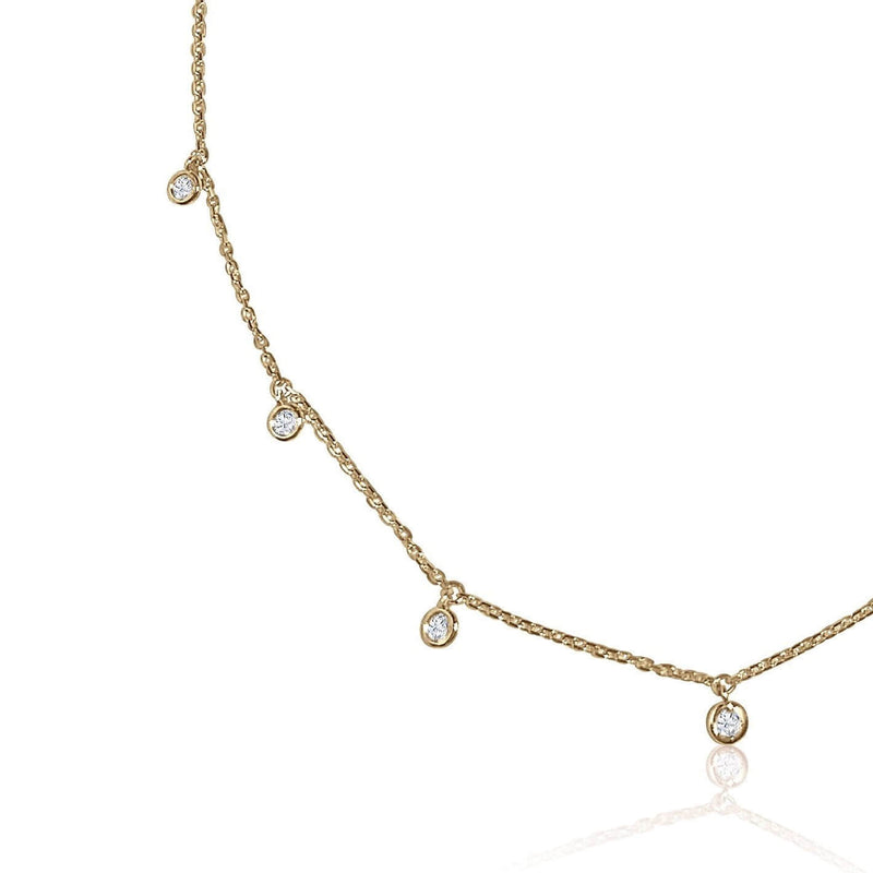A classic must-have to complement any look, this rainfall 18k gold necklace features seven dangling set diamonds