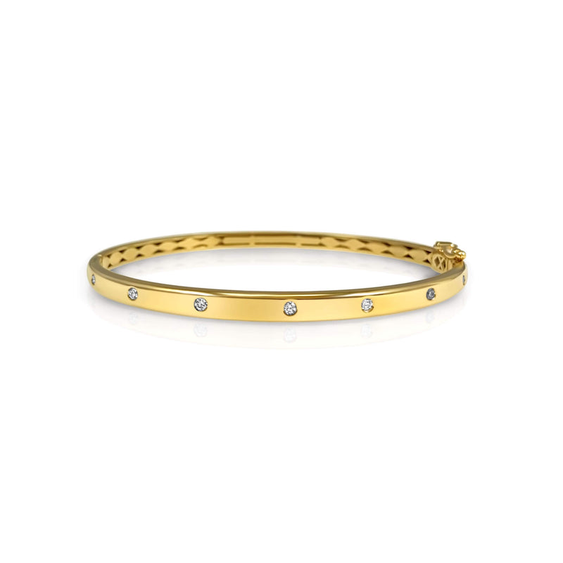 14K solid Gold (8.2g), 7 Diamonds (0.35 carats)  A gorgeous classic bangle bracelet with 7 perfect diamonds that would go perfectly alone or stacked for the perfect arm candy! The bangle has a safety clasp to keep it in place.   Available in Yellow, White and Rose Gold. 