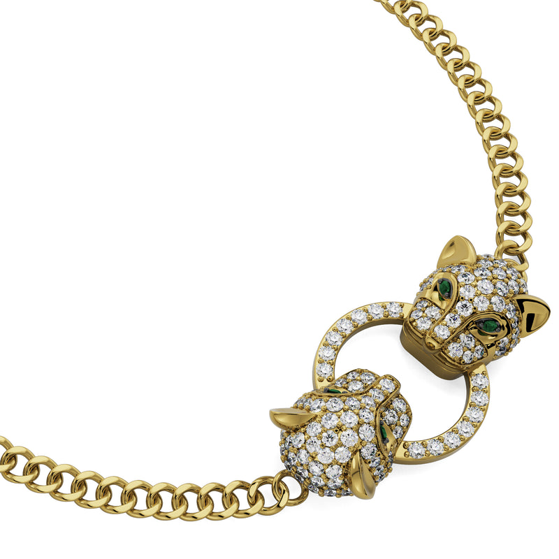 Specifications: 18K Solid Gold (2g), Diamonds (0.4 carats)  Statement bracelet with a double Jaguar head design with green emerald eyes and diamond pavé setting. The bracelet is made of 18K gold with an adjustable chain for a perfect fit.  Available to order in rose, white and yellow gold. 